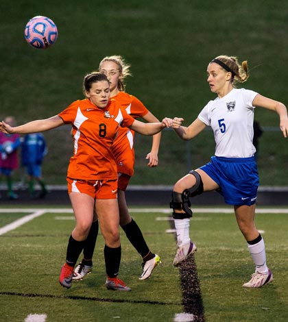 At right, Columbia's Taylor Kaempfe battles for the ball against Waterloo's Ali Scace earlier this season. (Alan Dooley photo)