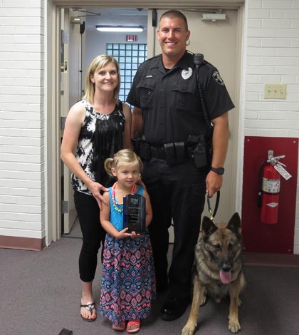 Pictured are Columbia Police Officer Zack Hopkins with his K-9, Daggo, along with wife, Kathy, and daughter, Kennedy, holding Hopkins’ and Daggo’s second place trophy from the recent regional K-9 trials hosted by Columbia Police Department.
(Andrea Saathoff photo)