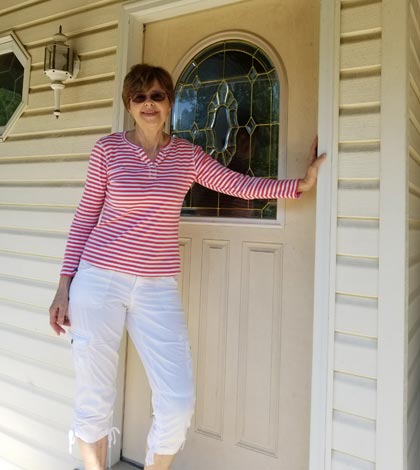 Gea Pierce stands at the front door of her home in her adopted community of Monroe County. Gea hails from The Netherlands.  (Deb Ruggeri photo)
