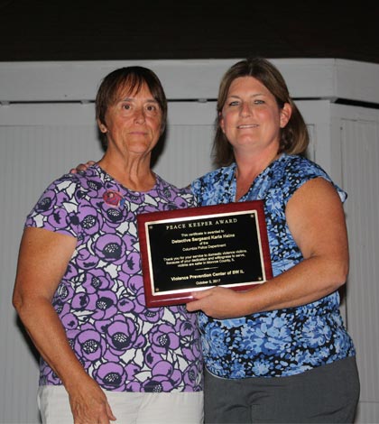 Pictured, Kay Clements of the Violence Prevention Center of Southwestern Illinois awards Columbia Police Detective Sergeant Karla Heine with the 2017 Monroe County Peacekeeper Award. (Sean McGowan photo)