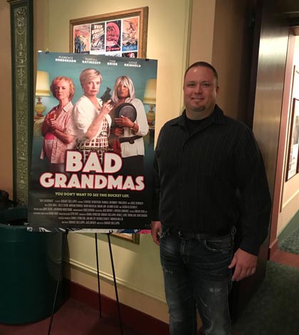 Pictured, Kyle Rainbolt of Charlie’s CARSTAR in Columbia stands next to the “Bad Grandmas” movie poster at the St. Louis International Film Festival on Thursday. (submitted photo)