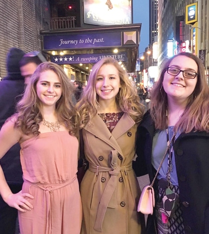 Pictured, from left, Gibault students Grace Floerke, Isabella Garcia and Hannah Janson stop to take a photo outside during their Broadway trip. (submitted photo)