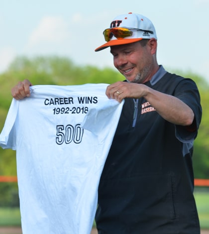 Waterloo High School baseball coach Mark Vogel holds a commemorative shirt following his 500th career victory last Wednesday. (John Spytek photo)