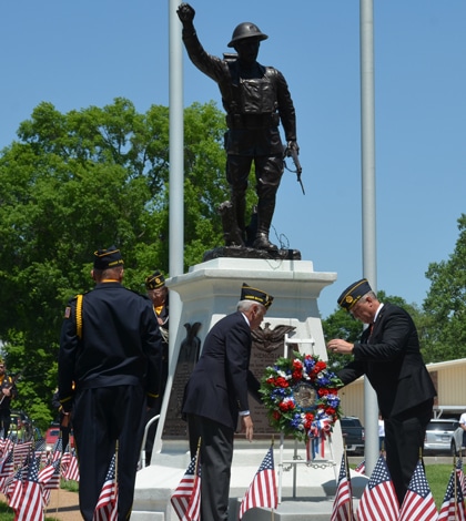 Columbia Mayor Kevin Hutchinson is joined by Columbia American Legion Honor Guard members and Legion Auxiliary officials in placing a ceremonial wreath at the Doughboy statue on Monday. (Andrea Saathoff photo)