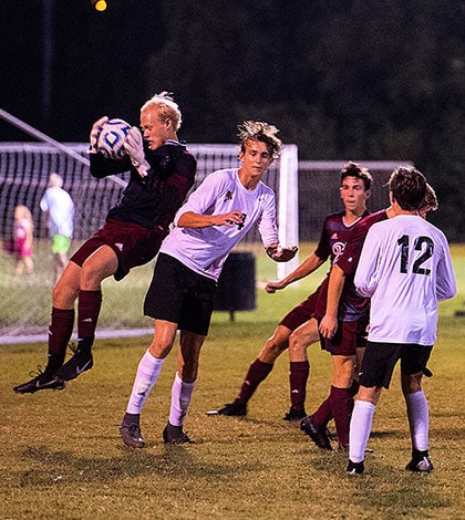 Gibault goalkeeper Connor Olson (left) secures the ball during a 3-2 win over Granite City on Sept. 20. (Alan Dooley photo)