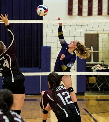 Valmeyer’s Kendra Goldschmidt sends the ball over the net during a recent match against Dupo. (Alan Dooley photo)