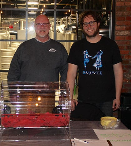 Pictured from left are Helping Strays Shelter Director Bill Dahlkamp and Hopskeller Brewing Company founder, head brewer and operating partner Matt Schweizer before the inaugural Queen of Hearts drawing at Hopskeller on Thursday. The winner selected a joker. 