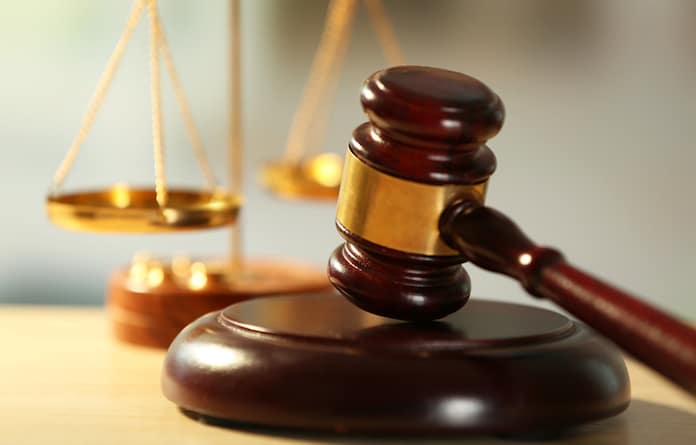 Wooden judges gavel on wooden table, close up