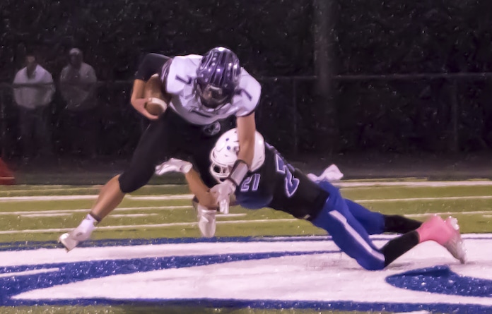 1F1A3181.jpg Col Kyle McConachie sacks the B Central qb Landon in the rain Geragosian for a loss in the rain