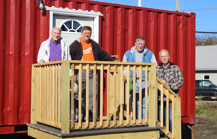 Pictured, from left, are Larry Summers, Marc Leeke and Ken Strain from Concord Baptist Church in South St. Louis County. At right is John Moll, a member of Faith Lutheran in Columbia, who serves as project manager for GSMMetro’s Housing Initiative. Moll and the others use their backgrounds in engineering and construction to best serve the ministry. The team poses in front of one of five container homes they helped construct on the ministry’s property. 