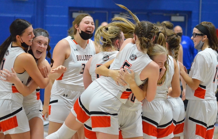 The Waterloo High School girls basketball team celebrates after winning the title game of the Columbia Tip-Off Classic on Saturday.