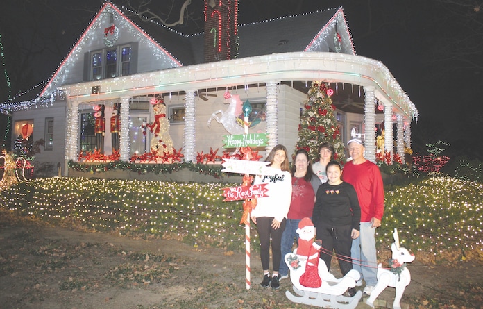 The Rose family poses among their kingdom of lights in downtown Columbia. Pictured, from left, are Emily, Victoria, Kyle, Taylor and Scott.