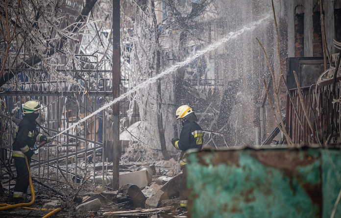 Firefighters extinguish the consequences of a fire after a rocket raid