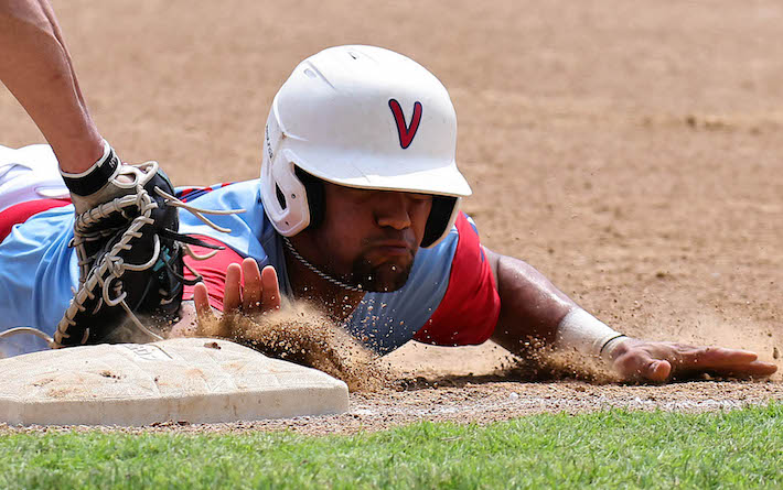 Kenny Otero of Valmeyer slides safely back to first base as Mike Breyman of Belleville applies the late tag on a pickoff attempt in game 1 of the Mon Clair League championship finals against Belleville in Valmeyer on Saturday, August 12, 2023. ,
