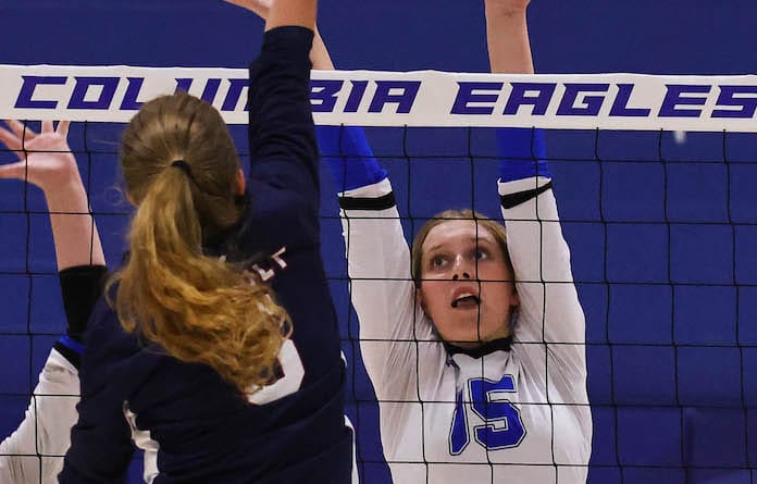 Claire Barbour (5) of Gibault attacks the net as Maura Kohlenberger (15) of Columbia defends the net in a vollyball match at Columbia High School on Monday, September 18, 2023.