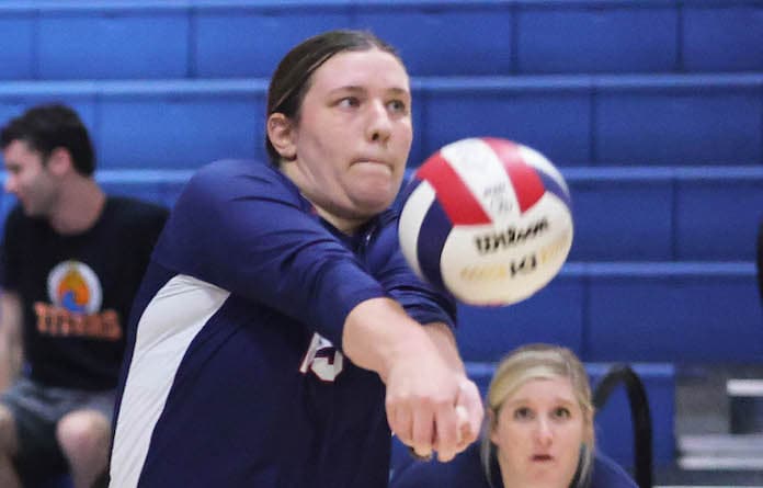 Kate Kreps (15) of Gibault returns a serve against Columbia in a vollyball match at Columbia High School on Monday, September 18, 2023.