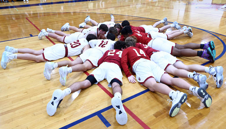 The Hawks form a circle for a last minute words of encouragement in their game against Routte Catholic at Gibault High School on Saturday, December 2, 2023