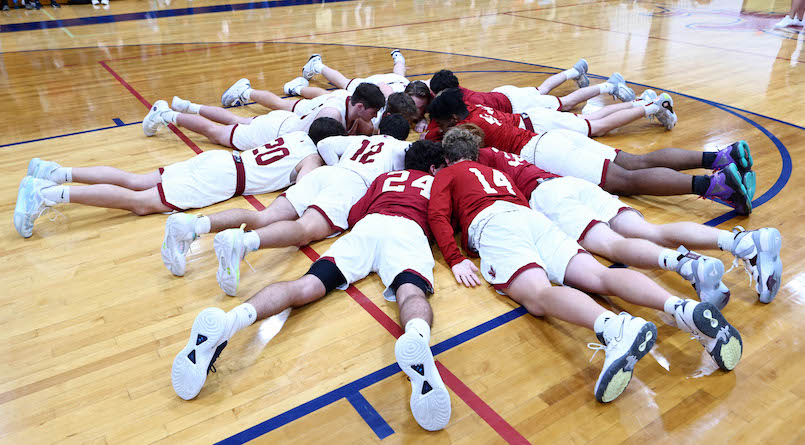 The Hawks form a circle for a last minute words of encouragement in their game against Routte Catholic at Gibault High School on Saturday, December 2, 2023