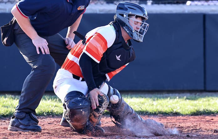 Chaten Kirchner (15) of Waterloo blocks a pitch in the dirt on a swinging strike three against Trico in a baseball game at Waterloo High School on Wednesday, March 27, 2024.