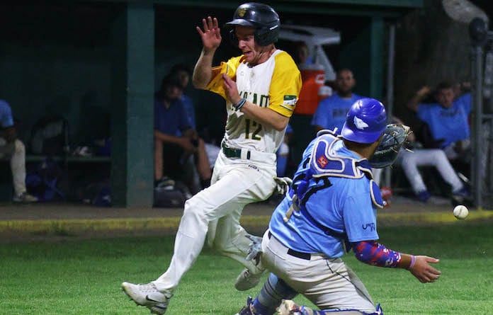 Colin Shea of Millstadt scores as catcher Hunter Mulholland can not handle the throw for Belleville in the Mon- Clair League baseball playoff championship at Borsch Park in Valmeyer on Saturday, August 10, 2024. Paul Baillargeon on Saturday, August 10, 2024. Paul Baillargeon