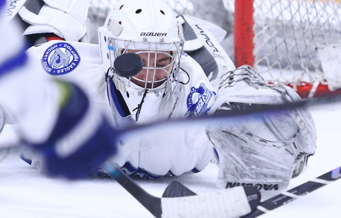 Ryder Kelly (50) of Coulumbia makes the save with his face mask against Highland at the McKendree Metro Rec Plex on Tuesday December 23, 2025. Paul Baillargeon