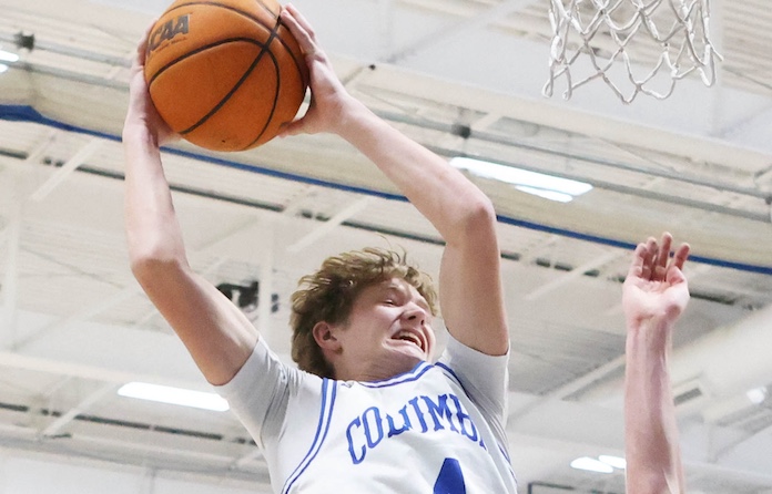 Ryker Nelson (4) of Columbia goes high for a rebound against Triad in a boys basketball game on Tuesday December 9, 2025 at Columbia High School. Paul Baillargeon