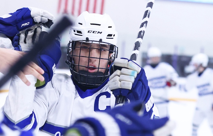 Kraig Spisak (81) of Columbia gets congratulated by his team along the bench in the game against Highland at the McKendree Metro Rec Plex on Tuesday December 23, 2025. Paul Baillargeon