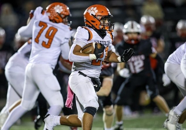 October 31, 2025 - Mt. Zion, IL - Waterloo's Derez Sayles carries the ball during Friday night’s IHSA Class 4A, first round football game between Waterloo and Mt. Zion.  [Photo: Chris Johns]