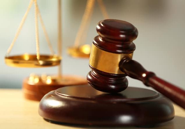 Wooden judges gavel on wooden table, close up