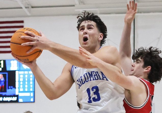 Eddie Smajic (13) of Columbia fights his way through the lane against Triad in a boys basketball game on Tuesday December 9, 2025 at Columbia High School. Paul Baillargeon